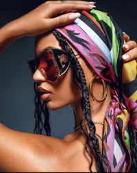 a woman wearing sunglasses and a colorful scarf